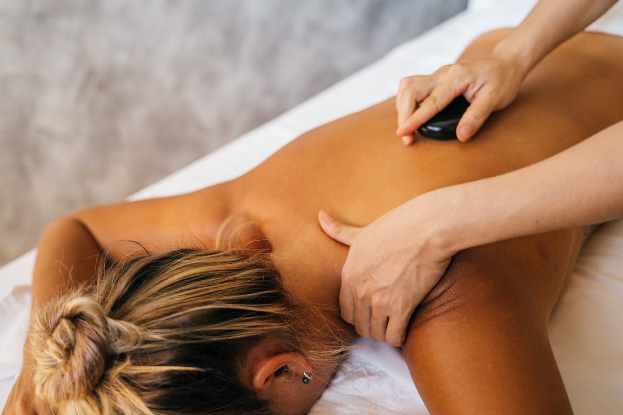 Experience deep relaxation with a hot stone massage, enhancing your wellness journey.